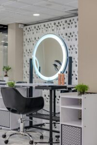 Elegant salon interior featuring a stylish setup with a ring light and mirror.