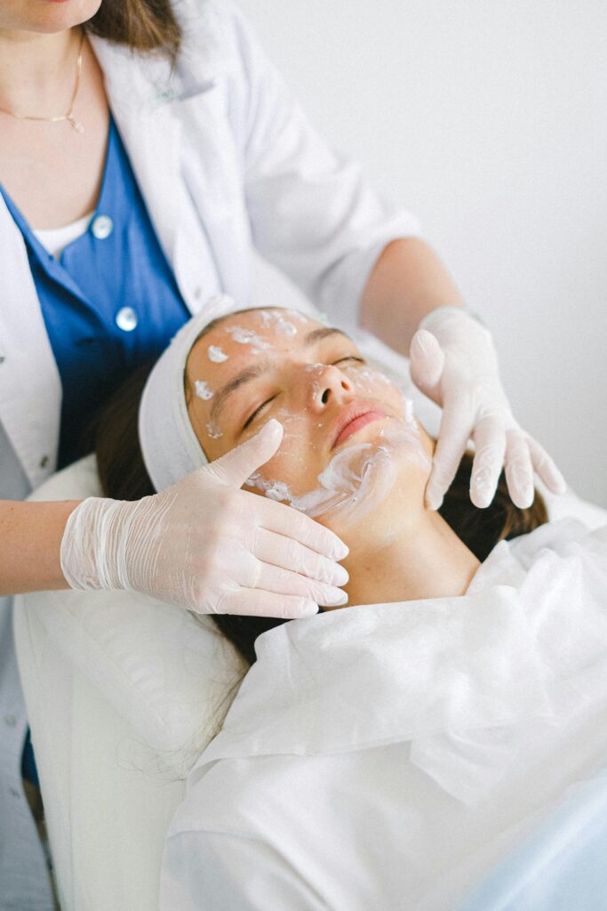 Which Treatment Is Permanent for Pigmentation? A Complete Guide From above of crop faceless cosmetician applying facial mask on customer face during cosmetic procedure in modern spa salon
